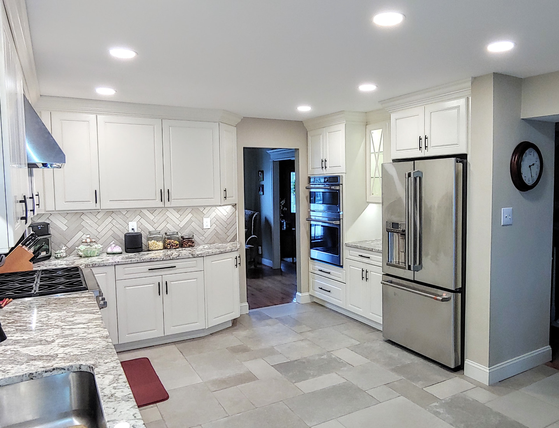 Kitchen project by The Cabinet Coach: White shaker kitchen with herringbone backsplash